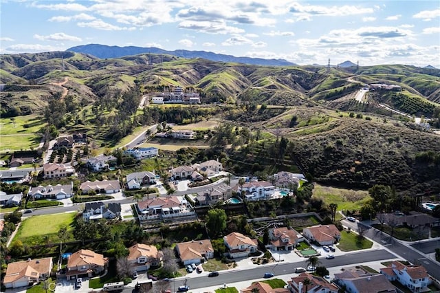 drone / aerial view featuring a residential view and a mountain view