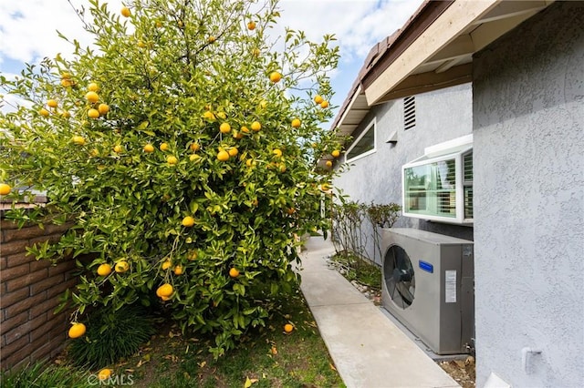 exterior space featuring ac unit and stucco siding