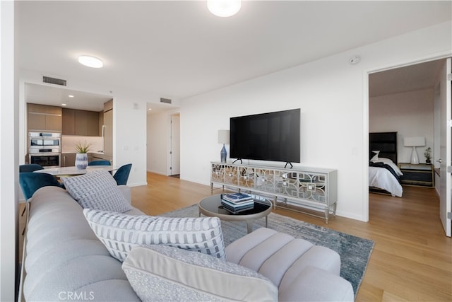 living room with light hardwood / wood-style flooring