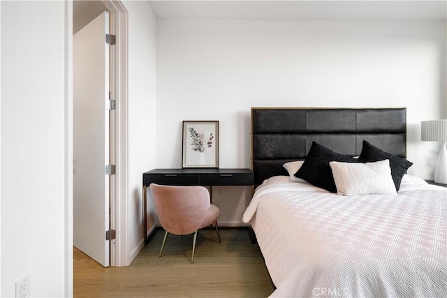 bedroom with wood-type flooring