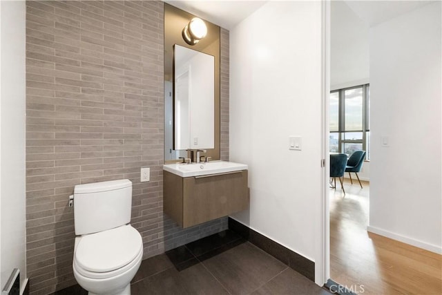 bathroom featuring wood-type flooring, toilet, and vanity