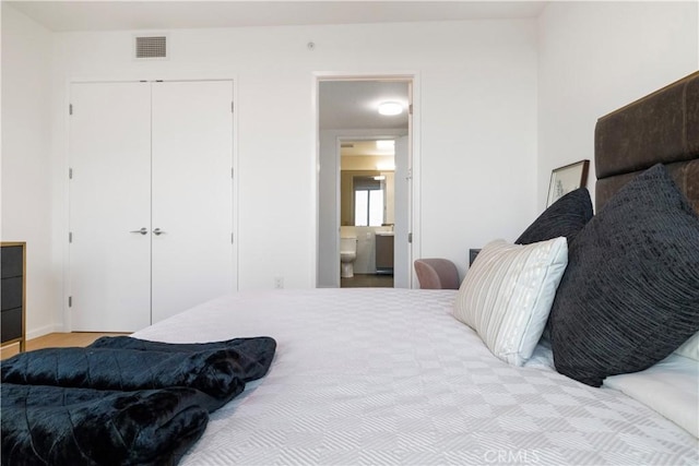 bedroom featuring a closet and ensuite bathroom