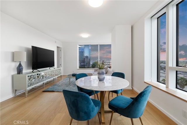 dining space with light hardwood / wood-style flooring