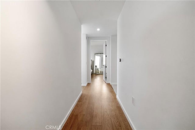 corridor with light wood-type flooring