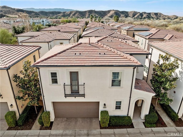 view of front of property featuring a garage and a mountain view