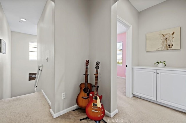 hallway with light colored carpet