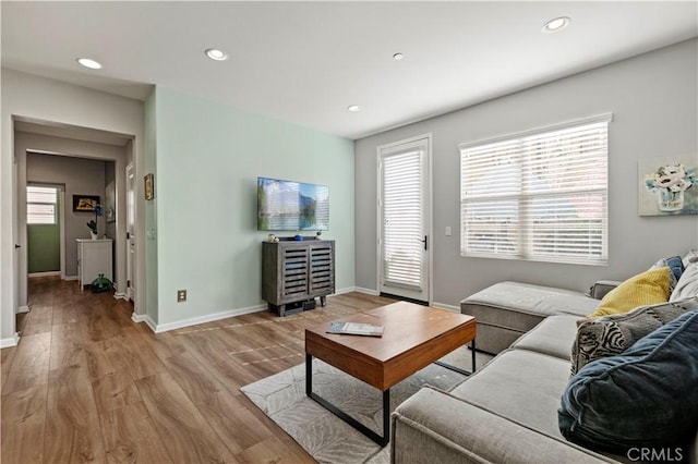 living room with plenty of natural light and light wood-type flooring