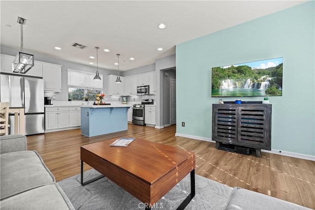 living room with light hardwood / wood-style flooring