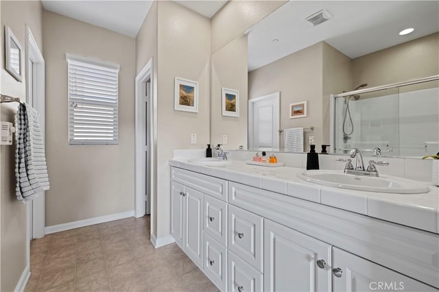 bathroom with vanity, tile patterned flooring, and walk in shower