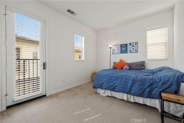 bedroom featuring light carpet