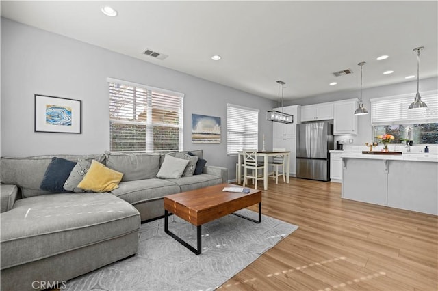 living room with light hardwood / wood-style flooring