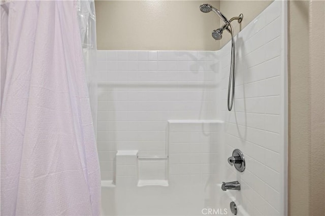 bathroom featuring shower / bathtub combination with curtain