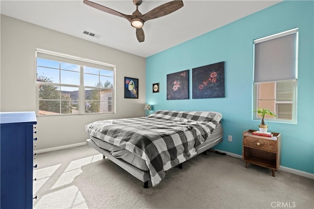 bedroom featuring light colored carpet and ceiling fan