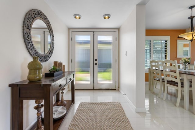 doorway to outside with french doors and light tile patterned floors