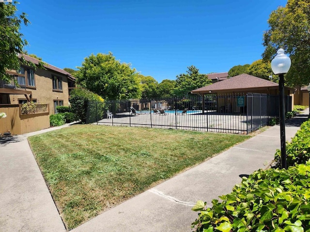 view of home's community featuring a lawn, a gazebo, and a swimming pool