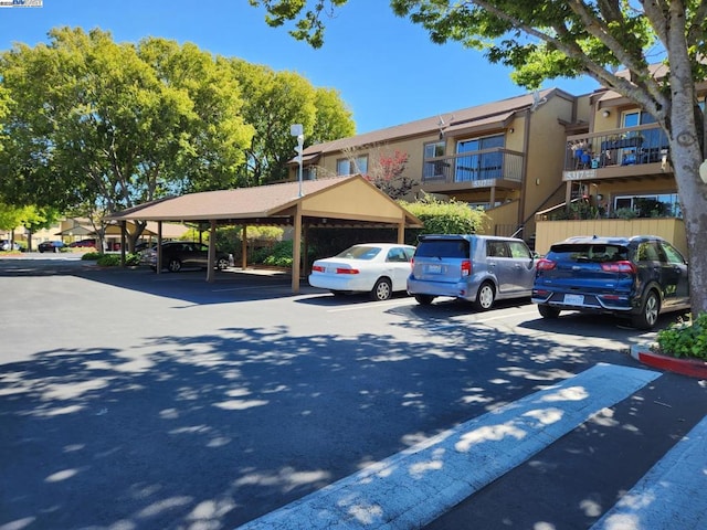 view of parking / parking lot featuring a carport