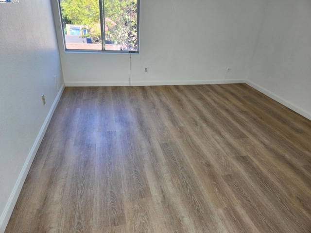 spare room with dark hardwood / wood-style floors