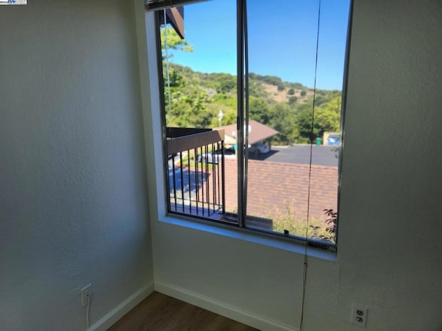 spare room with dark hardwood / wood-style flooring