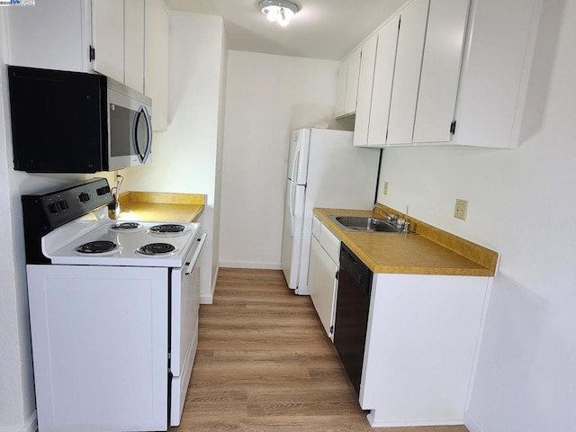 kitchen featuring white cabinets, white appliances, light hardwood / wood-style flooring, and sink