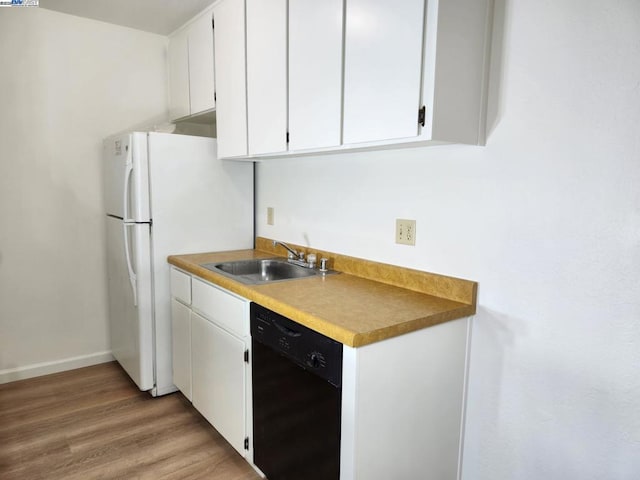 kitchen with sink, light wood-type flooring, white cabinetry, and black dishwasher