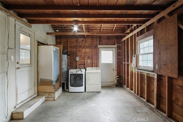 basement featuring wooden ceiling and washing machine and clothes dryer