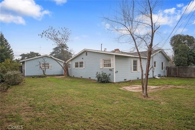 rear view of house with a lawn