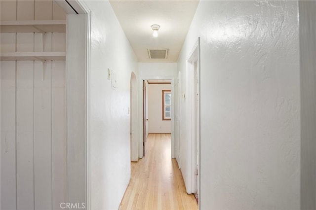 corridor with light hardwood / wood-style floors