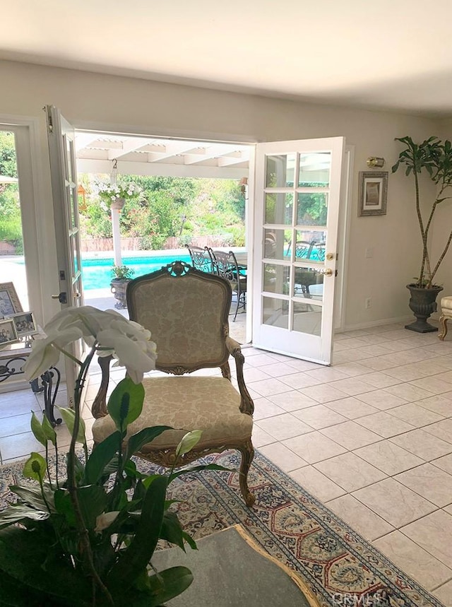 living area with french doors and light tile patterned floors