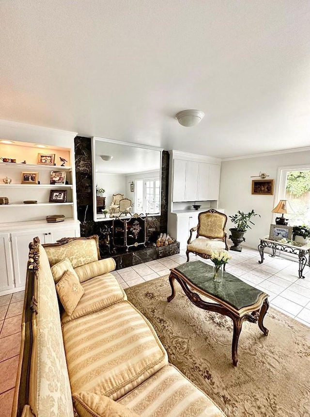 tiled living room featuring built in features and a healthy amount of sunlight