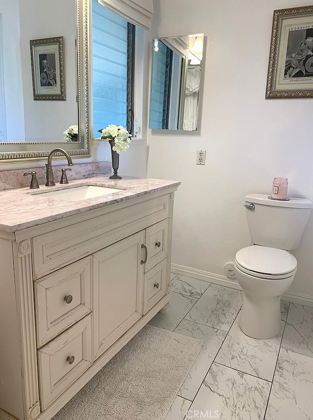 bathroom featuring vanity and toilet