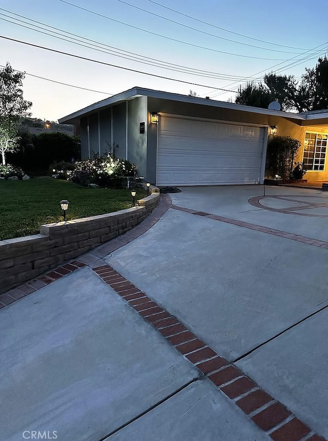 view of front of home with a front yard and a garage