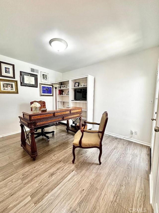 office area with light hardwood / wood-style floors