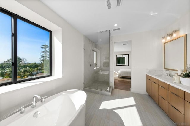 bathroom featuring vanity and shower with separate bathtub