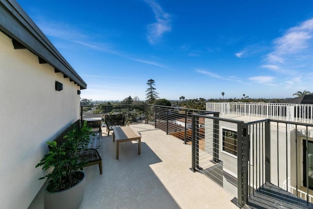 view of patio featuring a balcony