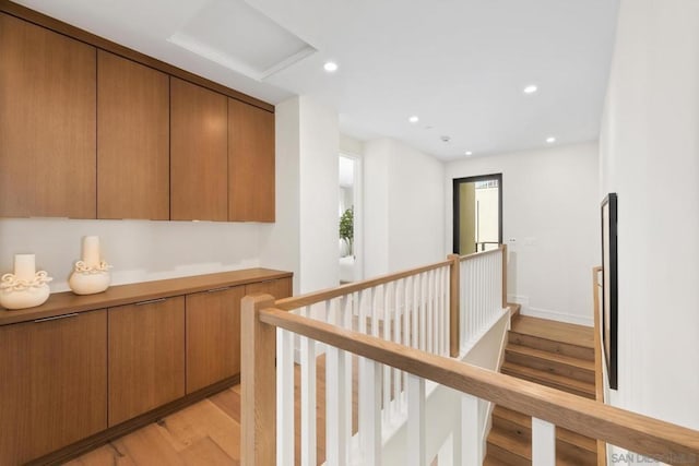 hallway with light hardwood / wood-style floors