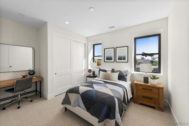 carpeted bedroom with a closet