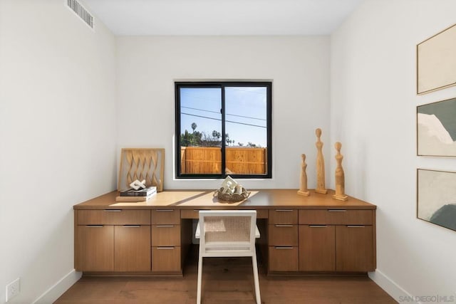 home office featuring built in desk and light hardwood / wood-style floors