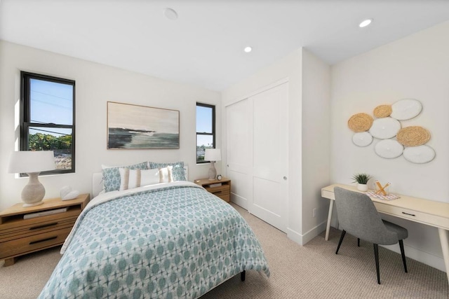 bedroom featuring light carpet and a closet