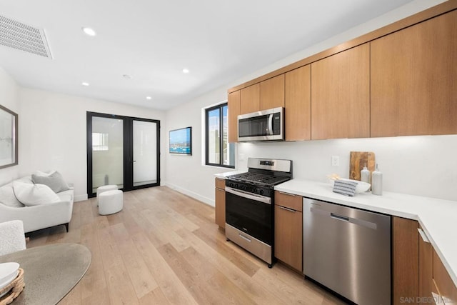 kitchen with stainless steel appliances and light wood-type flooring