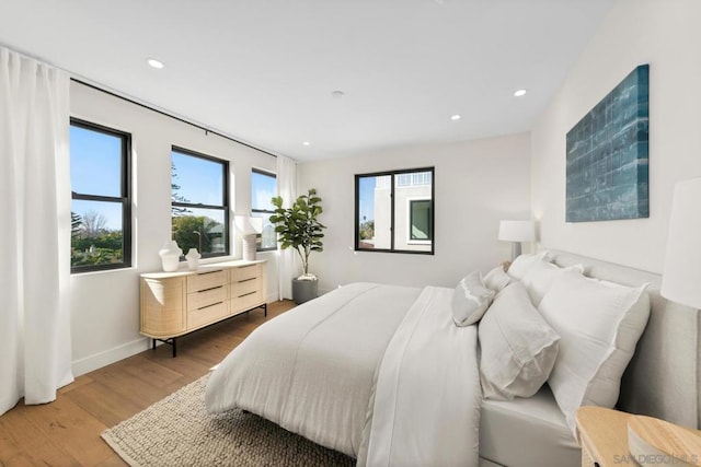 bedroom with hardwood / wood-style flooring