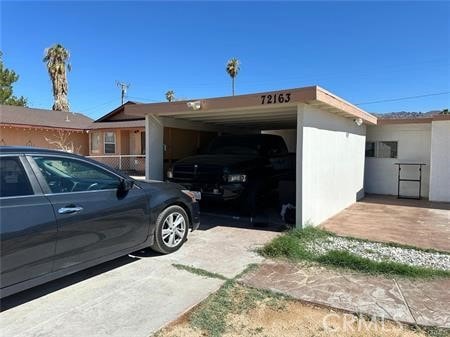 view of side of property with a carport