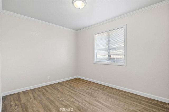 unfurnished room with hardwood / wood-style flooring and crown molding