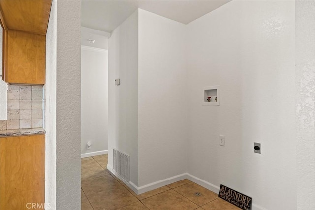 laundry room with washer hookup, light tile patterned floors, and hookup for an electric dryer