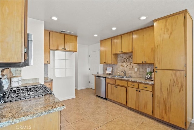 kitchen with dishwasher, sink, tasteful backsplash, stove, and light tile patterned flooring