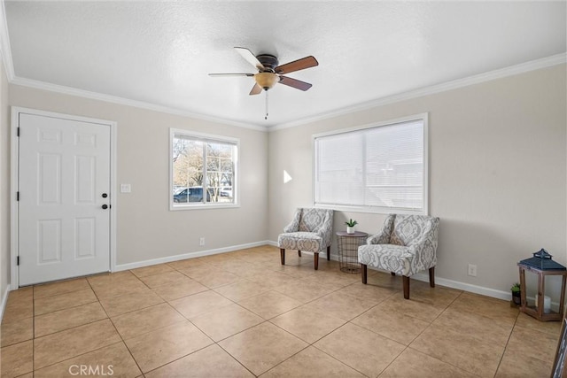 living area with ceiling fan, ornamental molding, and light tile patterned floors