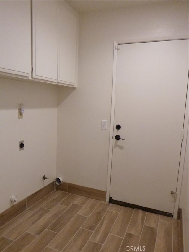 washroom with hookup for an electric dryer, cabinets, washer hookup, and hookup for a gas dryer