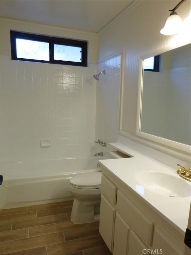 full bathroom with tiled shower / bath combo, vanity, crown molding, and toilet