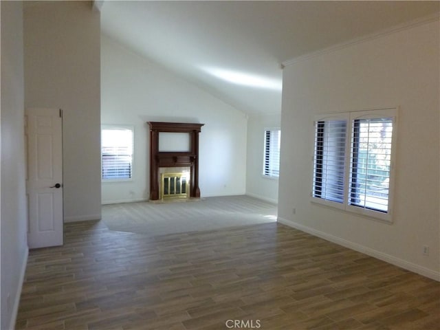 unfurnished living room featuring high vaulted ceiling, dark wood-type flooring, and ornamental molding