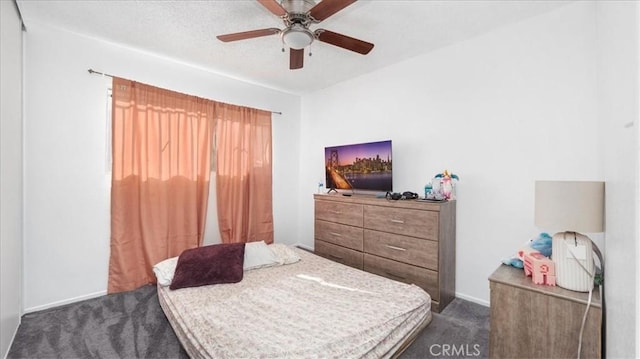 carpeted bedroom featuring a textured ceiling and ceiling fan