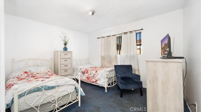 bedroom with dark colored carpet